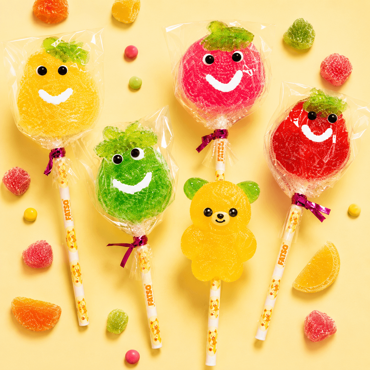 Flatlay of Fatso rainbow lollipops and smiley candy pops